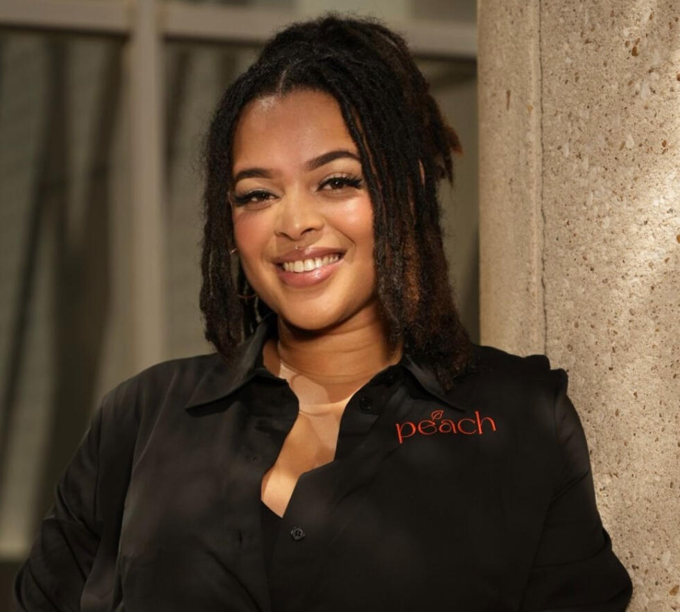 Nyla Bland smiling as the founder of Peach Marketing Firm